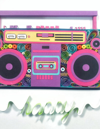 A picture of a boombox made from rolled pieces of paper