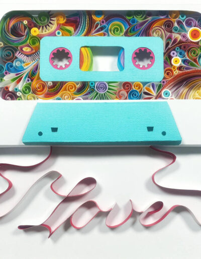 A quilled image of a cassette tape